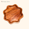 Round wooden dinner plate made from solid mango wood with natural brown finish for serving food.